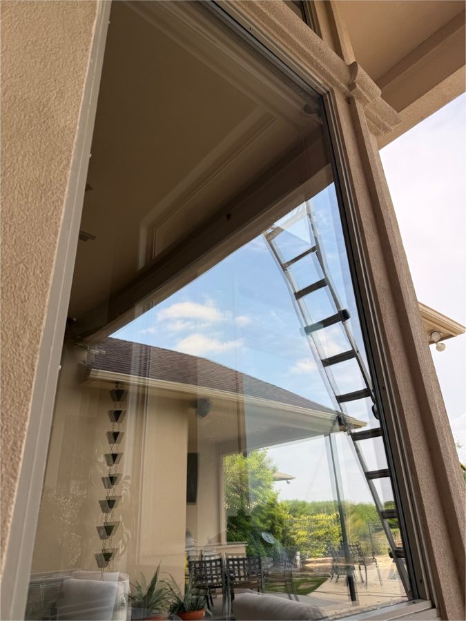 Clean window with a ladder reflection in the glass