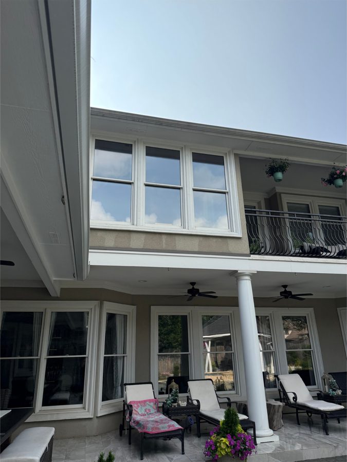 Two-story home with spotless windows and a shaded patio