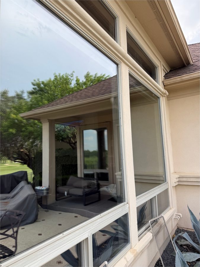 Sparkling picture windows on a tan stucco home
